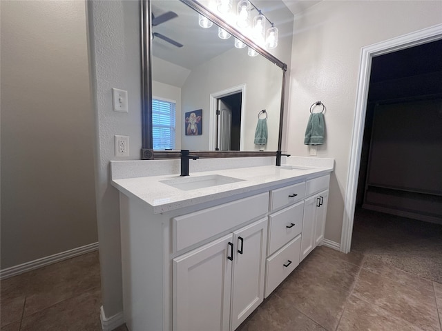 bathroom with tile patterned flooring, vanity, and lofted ceiling