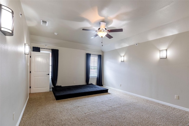 interior space with ceiling fan and carpet