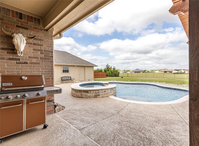 view of swimming pool with area for grilling, an in ground hot tub, a yard, and a patio