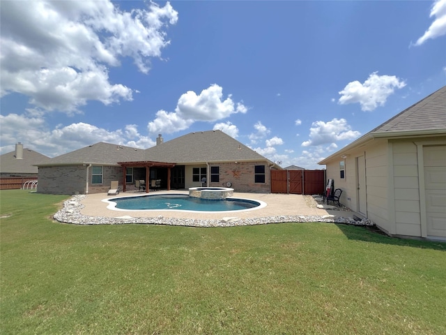 view of swimming pool with an in ground hot tub, a yard, and a patio