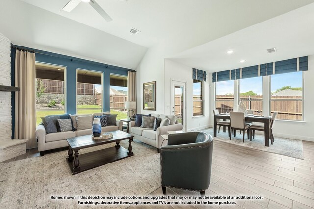 living room with hardwood / wood-style flooring, ceiling fan, and lofted ceiling