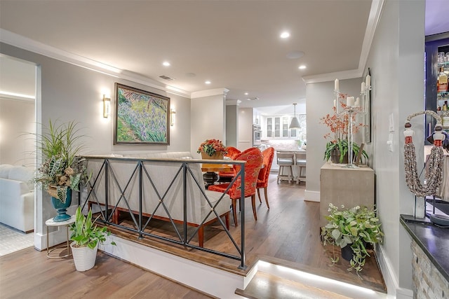 dining room featuring hardwood / wood-style flooring and crown molding