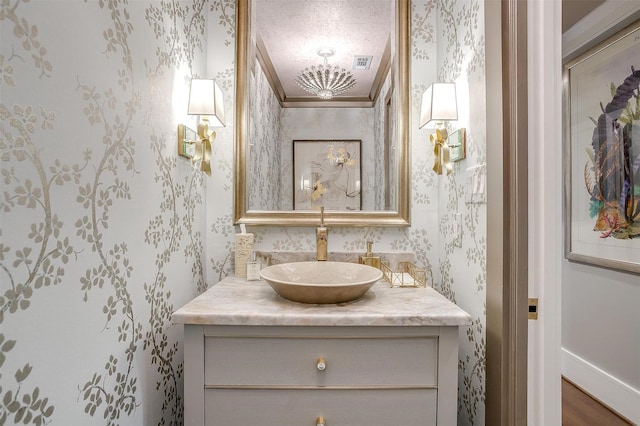 bathroom featuring vanity and ornamental molding