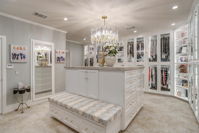 walk in closet featuring light colored carpet and a chandelier