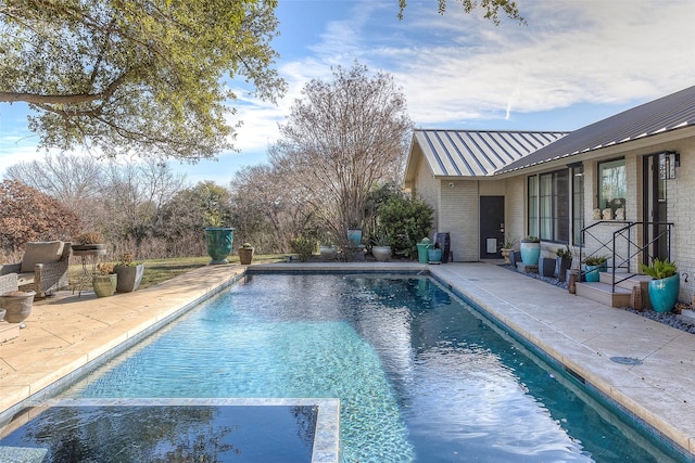 view of pool featuring a patio