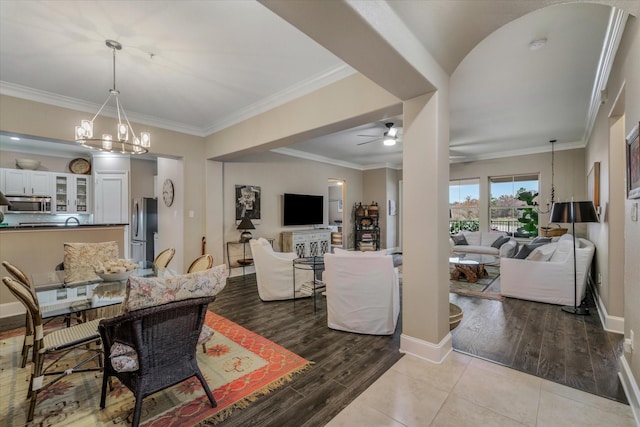 3351 Cascades Ct Unit 305, Tyler, TX 75709 - dining room featuring wood finished floors, a ceiling fan, a chandelier, and ornamental molding