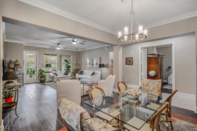 dining space featuring ornamental molding, dark hardwood / wood-style flooring, and an inviting chandelier