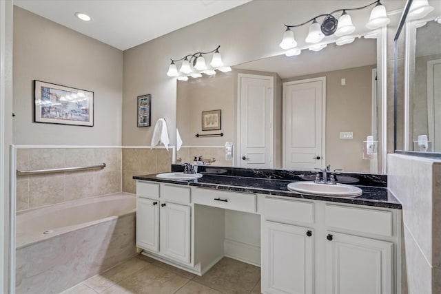 bathroom with tile patterned floors, vanity, and a bathing tub