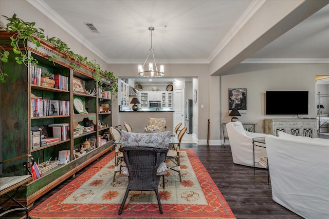 dining space with crown molding, dark hardwood / wood-style flooring, and a notable chandelier