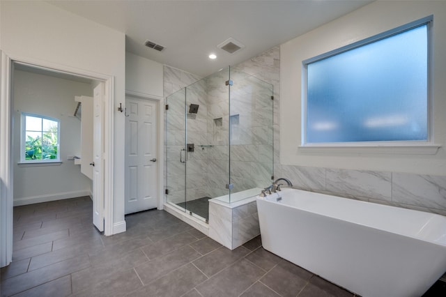 bathroom with tile patterned floors and independent shower and bath