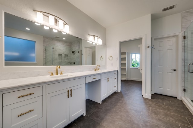 bathroom with tile patterned floors, vanity, and walk in shower