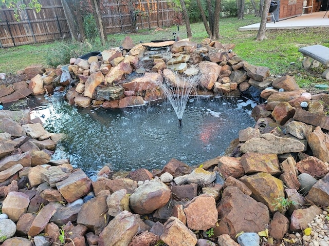 view of yard with a small pond