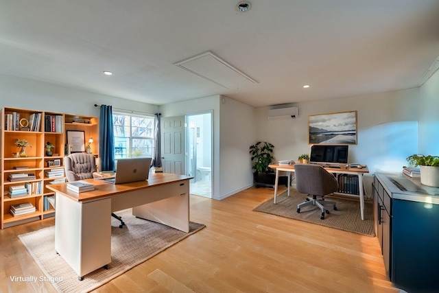 office featuring light hardwood / wood-style floors and a wall unit AC