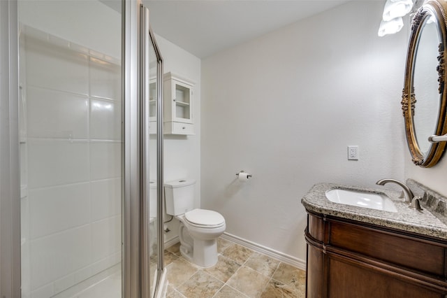 bathroom featuring vanity, toilet, and walk in shower