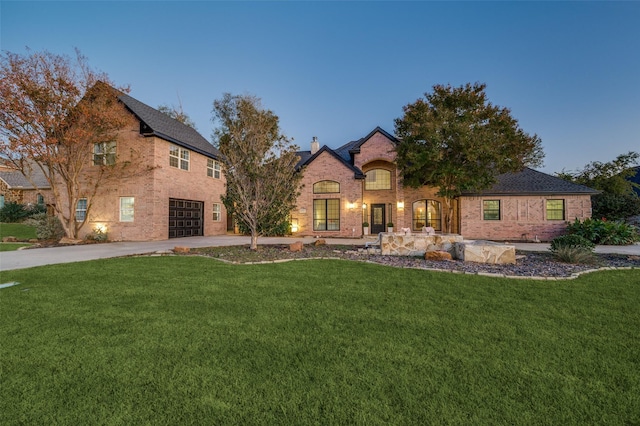 view of front of house with a lawn and a garage