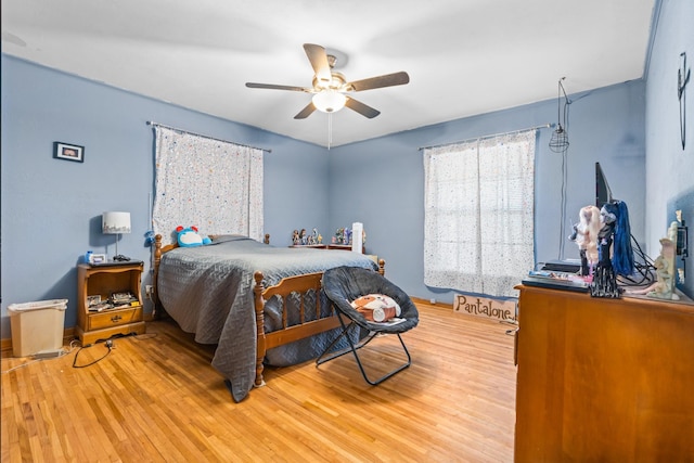 bedroom with ceiling fan and light wood-type flooring