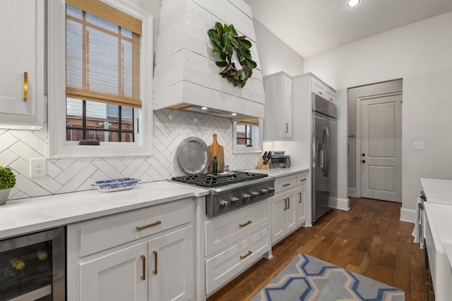 kitchen featuring white cabinetry, appliances with stainless steel finishes, dark wood-type flooring, and beverage cooler