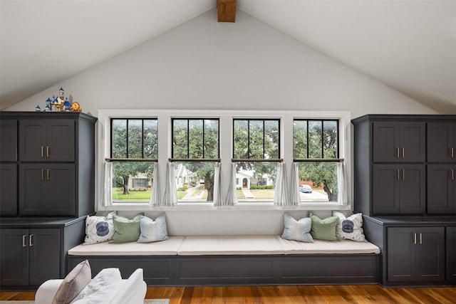 sitting room with vaulted ceiling with beams and light wood-type flooring