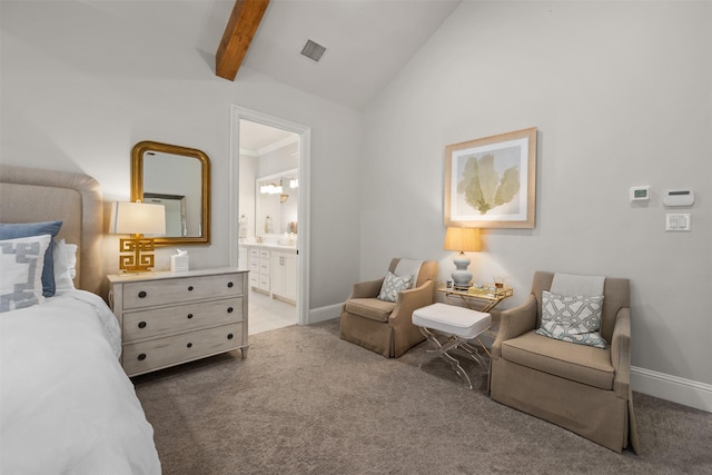 bedroom with connected bathroom, lofted ceiling with beams, and light carpet