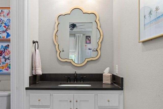 bathroom featuring vanity and toilet