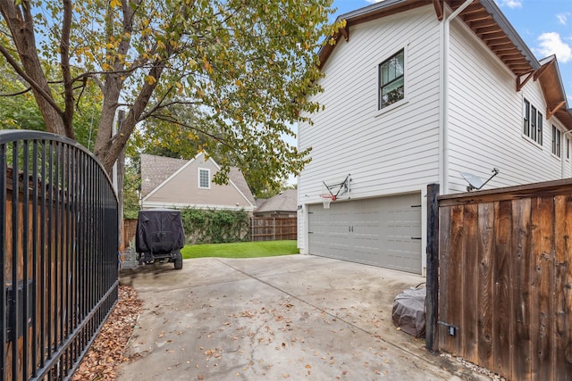 view of side of home with a garage and a lawn