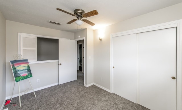 unfurnished bedroom featuring ceiling fan, a closet, and carpet