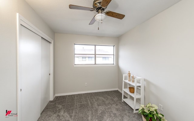 unfurnished bedroom featuring ceiling fan, dark carpet, and a closet