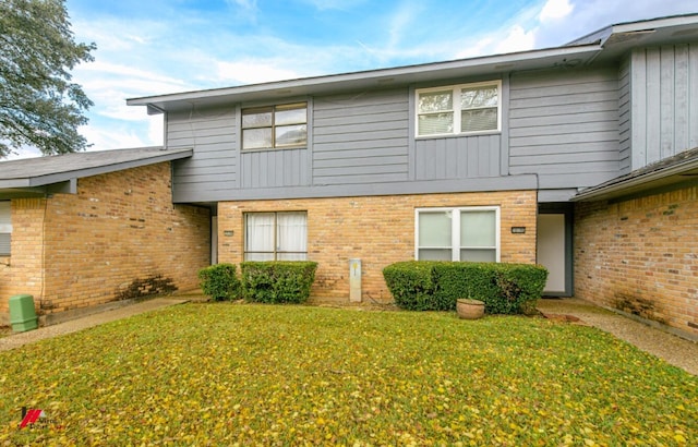 rear view of property with a yard