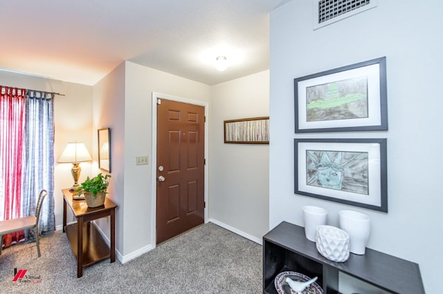 foyer entrance with carpet