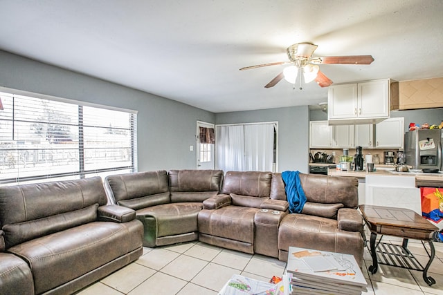 tiled living room with ceiling fan