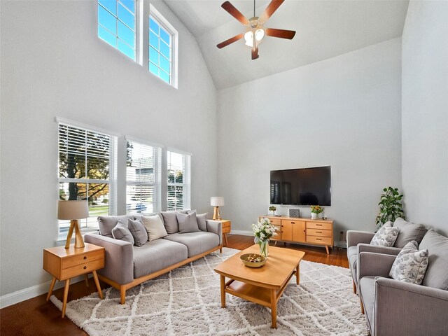 living room featuring hardwood / wood-style flooring, high vaulted ceiling, and ceiling fan