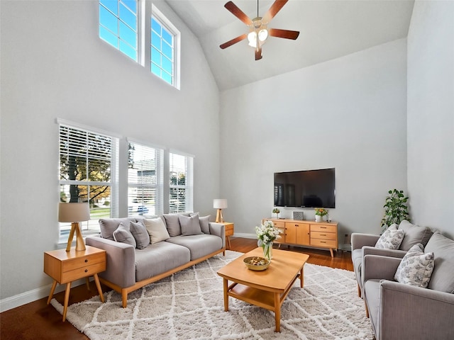 living room featuring hardwood / wood-style flooring, ceiling fan, plenty of natural light, and high vaulted ceiling