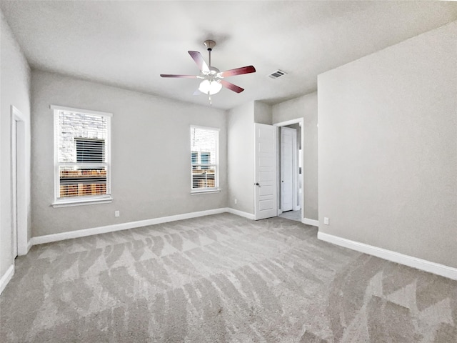 unfurnished bedroom featuring light colored carpet and ceiling fan