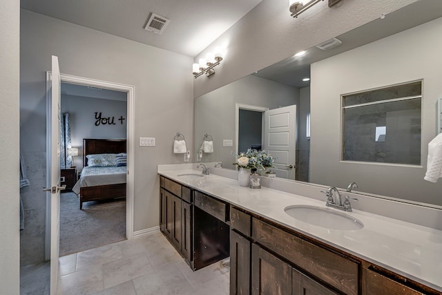 bathroom featuring tile patterned flooring, vanity, and a textured ceiling