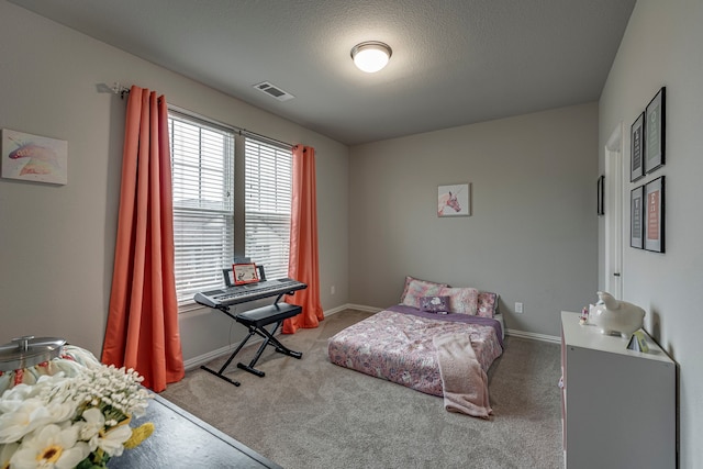 carpeted bedroom featuring a textured ceiling