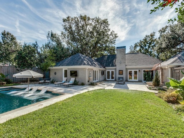 back of house with a lawn, french doors, and a patio