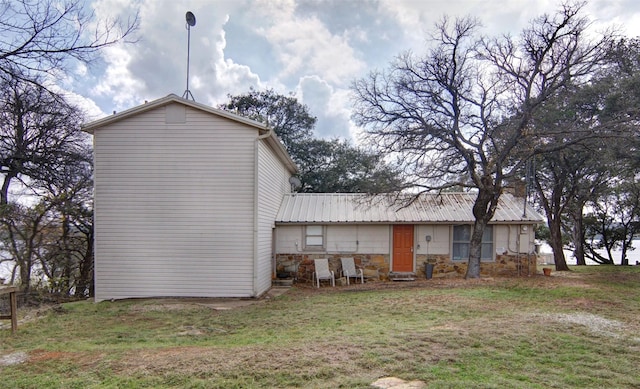 rear view of property with a lawn