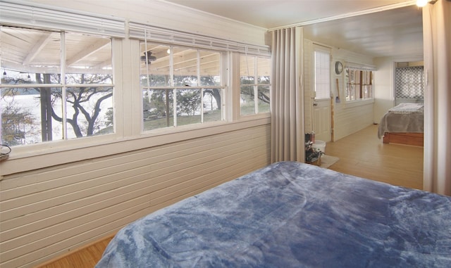 bedroom with wood-type flooring and wood walls