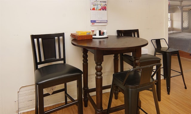 dining space with hardwood / wood-style flooring