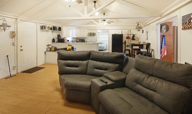 living room featuring lofted ceiling with beams, ceiling fan, and light hardwood / wood-style flooring