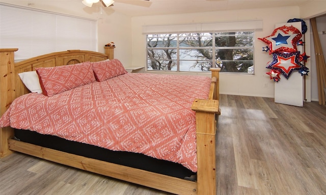 bedroom with hardwood / wood-style floors and ceiling fan