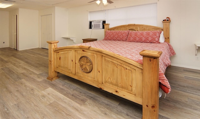 bedroom featuring cooling unit, ceiling fan, and wood-type flooring