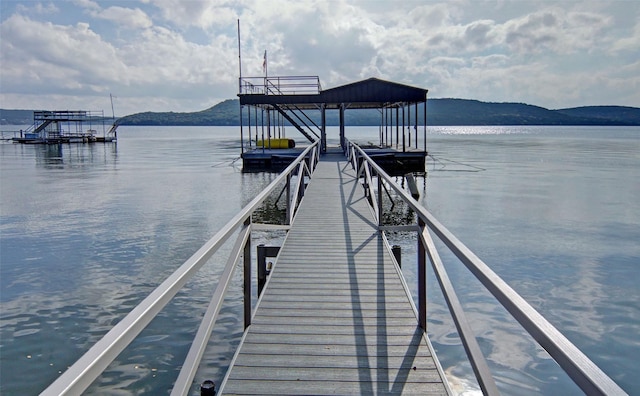 view of dock featuring a water and mountain view