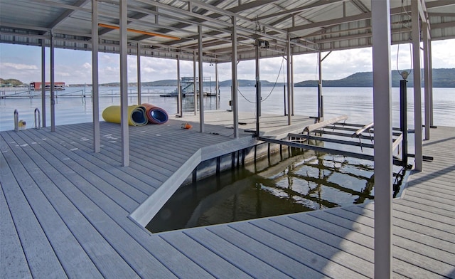 view of dock featuring a water and mountain view