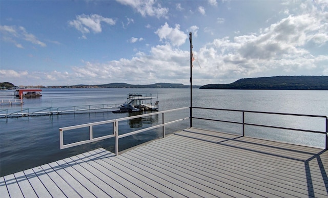 view of dock featuring a water and mountain view