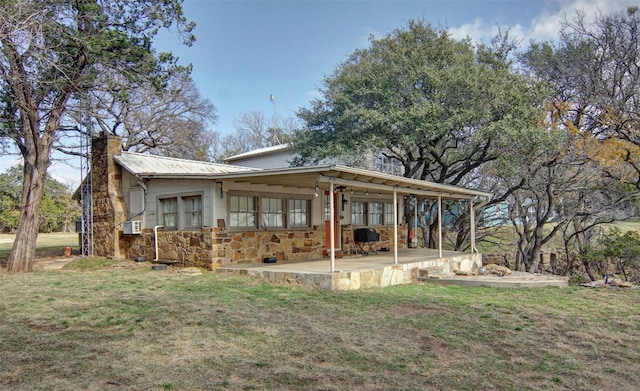 rear view of house with a yard and a patio