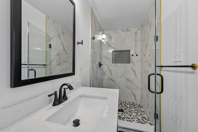 bathroom featuring vanity and a shower with door