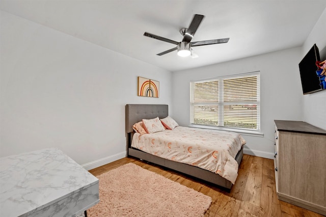 bedroom with ceiling fan and light wood-type flooring