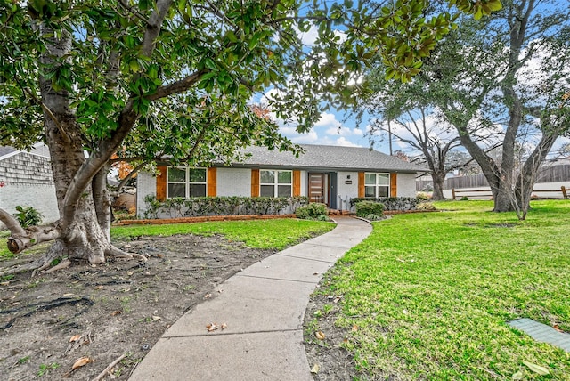 ranch-style home featuring a front yard