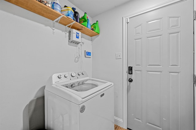 laundry room featuring hardwood / wood-style flooring and washer / dryer